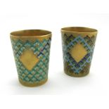 A Pair of Russian Silver Gilt and Enamel Beakers/Tots, one highlighted in blue and green, the