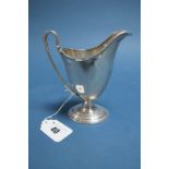 A Hallmarked Silver Jug, Walker & Hall, Sheffield 1912, with reeded edge and high loop handle, on