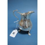 A Hallmarked Silver Jug, Roberts & Belk, Sheffield 1945, of plain baluster form with wavy cut