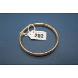 A 9ct Gold Bangle, (hallmark indistinct) of plain design.