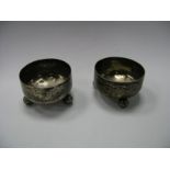 A Pair of Victorian Hallmarked Silver Salts, each of circular form, raised on three ball feet.