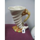 A Circa 1940's Clarice Cliff Jug, moulded as a conche shell with loop handle and handpainted foliate