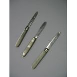 Three Hallmarked Silver Bladed Folding Fruit Knives, each with decorative mother of pearl scales. (