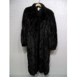 A Mink Coat, ankle length in dark brown with collar, sleeve gathered at wrist, with an overall