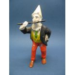 A Lead Figure in the Form of a Clown Playing a Flute, 10cms high.