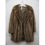 A Light Brown Mink Coat, three-quarter length with half belt to back, 82cms long.