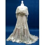 A Late XIX/Early XX Century Evening Dress, in oyster silk with lace overlay to empire line bodice,