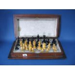 A Late Victorian Wooden Folding Chess Board/Case, 46 x 46cms, with complete 'Staunton' style chess