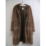 A Lady's Full Length Light Brown Fur Coat.