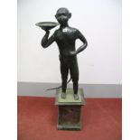 An Early XX Century Black Painted Lead Figure of an Ape, naively modelled standing, holding a
