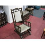 Early XX Century American Rocker, with shaped top rail, upholstered back panel, upholstered seat,