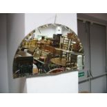 A XX Century Half Round Mirror, with a scallop edge and inclusions.