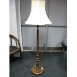 A Mahogany Standard Lamp, leaf carved and fluted column on foliate circular base, with shade.