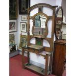 An Early XX Century Art Nouveau Style Oak Hallstand, with an arched top, shaped central mirror,