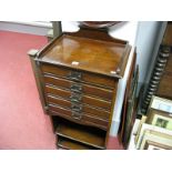 An Edwardian Mahogany Music Score Cabinet, three quarter gallery over a bank of five fall front