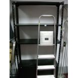 A Metal Shelving Unit Above Cupboard Doors, and a set of aluminium household steps. (2)