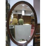 Early XX Century Mahogany Oval Shaped Wall Mirror, with a bevelled glass.