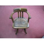 A Circa 1940's Oak and Mahogany Captains Chair, shaped bow back over latt splat, open arms,