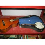 A Banjolele, stained wood body, four string (cased), and an Almeria acoustic guitar. (2)