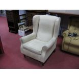 A Late XX Century Wingback Armchair, in cream dralon.