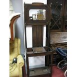 A 1940's Oak Hallstand, with a rectangular shaped mirror, glove compartment, undershelf with drop