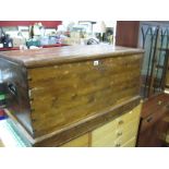 A XIX Century Pine Blanket Box, with hinged lid, carrying handles, on a plinth base.