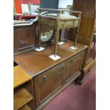 An Early XX Century Walnut Mirror Back Sideboard, the back with a circular mirror, base with two