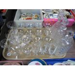 Three Cut Glass Decanters, sixteen champagne and five other drinking glasses:- One Tray