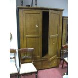 A Modern Stained Oak Double Wardrobe, with two panelled doors over two short drawers, stile ends.