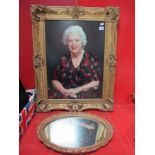 A Gilt Picture Frame, having applied scroll mounts aperture, 56x41cms. An oval gilt wall mirror. (