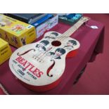 A 1960's Selcol "Beatles" Toy Guitar. 59cms long. Guitar pictures all four Beatles. Appears complete