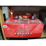A 1/18th Scale "Hotwheels" Racing F1 Ferrari, on plinth with figure of Michael Schumacher and sample