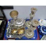 A Pair of Plate on Copper Candlesticks, plated three piece tea-service, plated goblet etc:- One