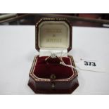 A Single Stone Ring, the brilliant cut stone illusion set, stamped "18ct&Plat" and inscribed "24-