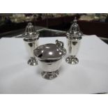 A Hallmarked Silver Three Piece Cruet Set, (marks rubbed), each of plain design, on pedestal base.