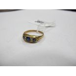 A Sapphire and Diamond Seven Stone Ring, graduated set with old cut diamond spacers, indistinctly