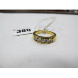 An 18ct Gold Five Stone Diamond Ring, channel set with uniform brilliant cut diamonds, between plain