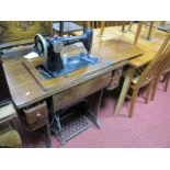 Singer Treadle Sewing Machine, in oak casing having four drawers.