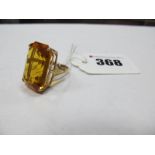 A Large 9ct Gold Single Stone Dress Ring, corner claw set high between trifurcated shoulders.