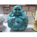 A Buddha, ceramic seated Buddha decorated in a turquoise glaze.