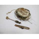 An Oval Cameo Brooch, collet set within openwork border; a two stone inset bar brooch,