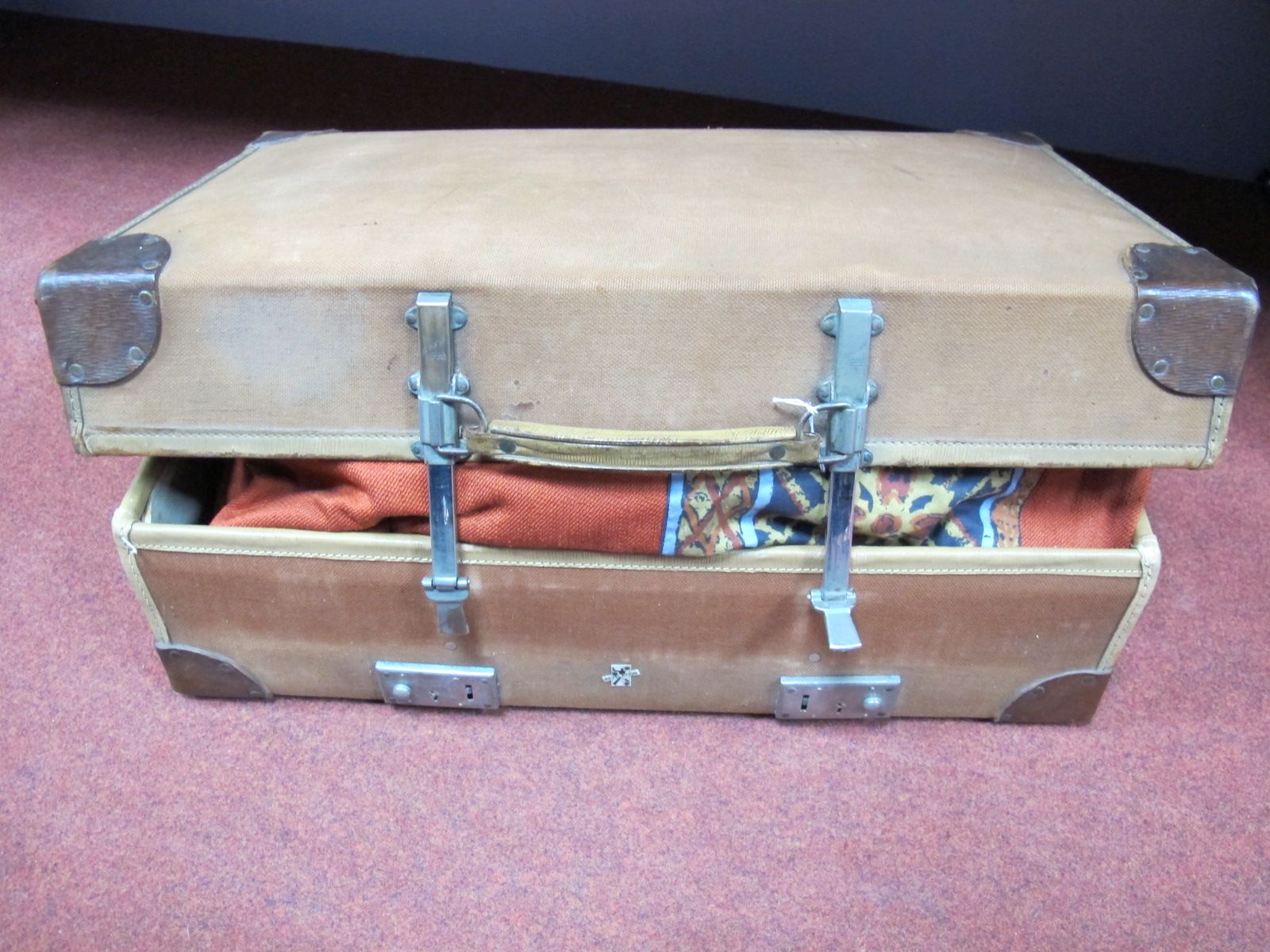 A Canvas and Leather Expanding Revelation Suitcase, containing a pair of large 1970's curtains.