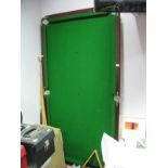 A Child's Snooker Table, approximately 1/4 size, on folding legs. Together with cues, balls and