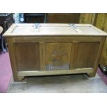 A XX Century Oak Blanket Box, with a hinged lid, three panelled base with central carved panel of