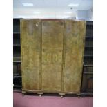 A Mid XX Century Burr Walnut Triple Door Wardrobe, on cabriole legs together; with bed ends.