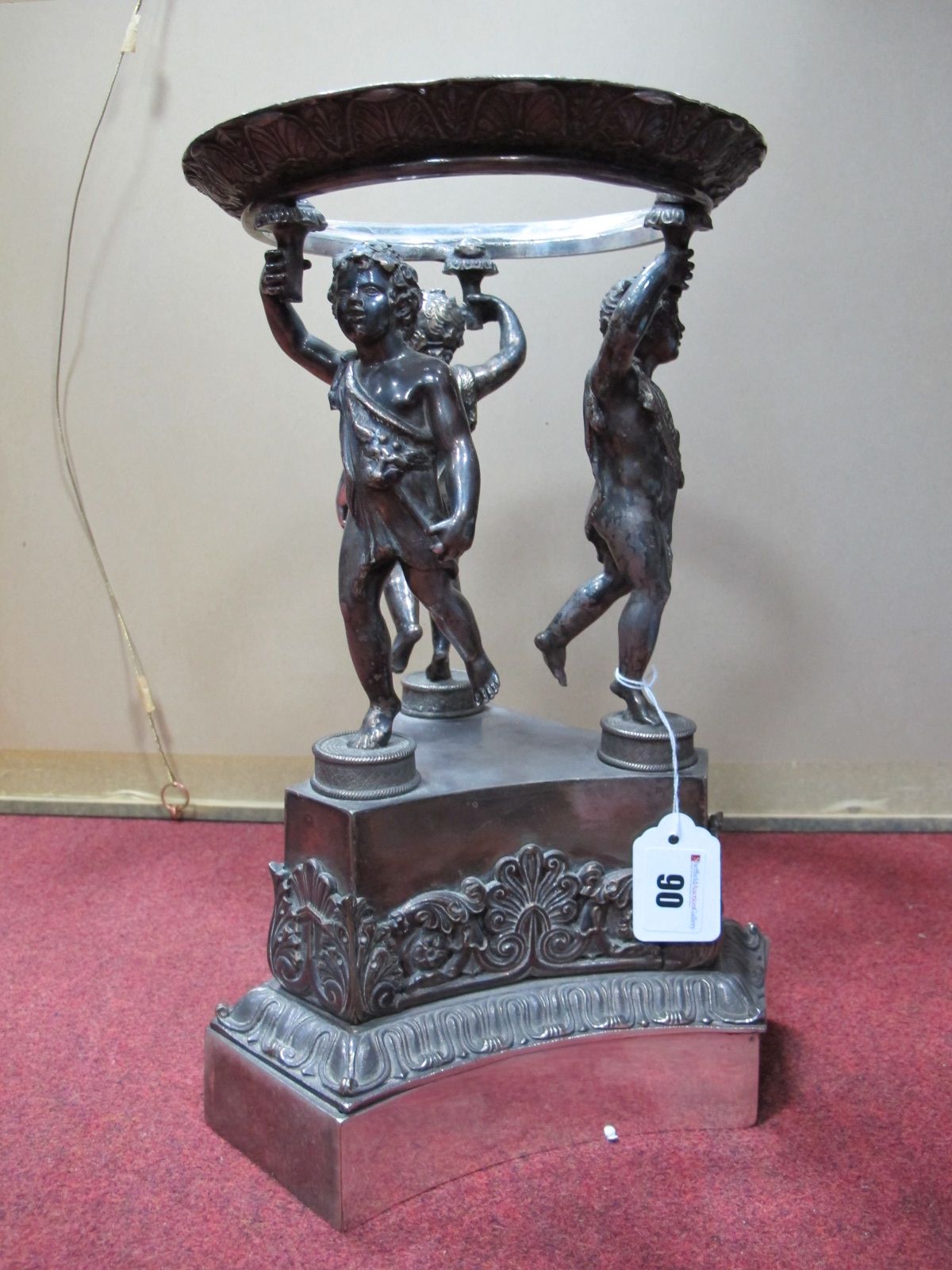 A Victorian Electroplated Table Centrepiece Stand, modelled with three torch bearing putti dressed
