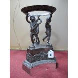 A Victorian Electroplated Table Centrepiece Stand, modelled with three torch bearing putti dressed