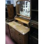 An Early XX Century Oak Dressing Table, with a central mirror, over jewel drawer, base with three
