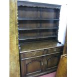 A XX Century Oak Dresser, the panelled back with three shelves, the base with two small drawers over