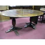 A XX Century Twin Pedestal Dining Table, with an oval top, on cup cover supports on a quatrefoil